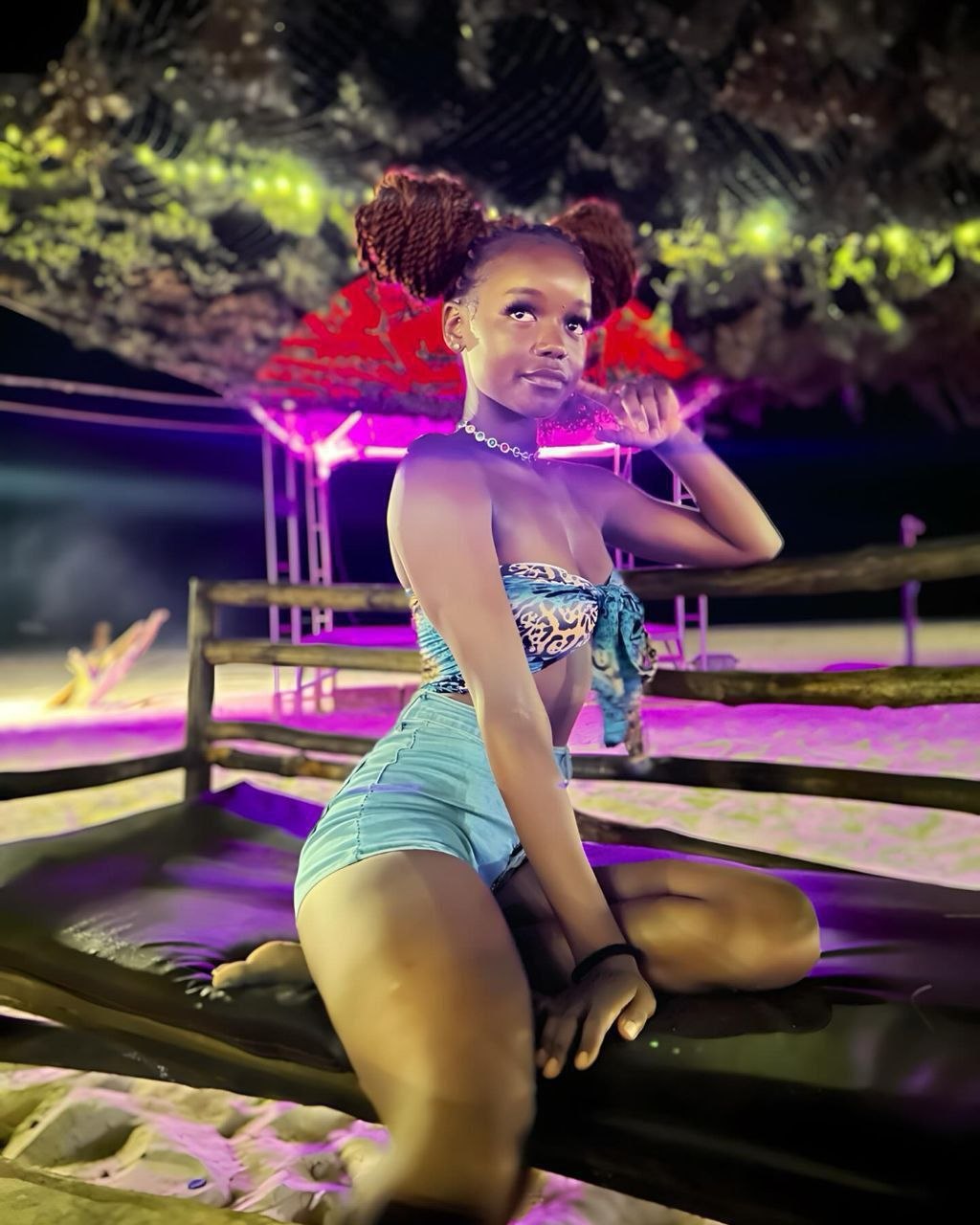 mmeona hii? waaah Alicia Kanini does a woman in a bikini sitting on a dock